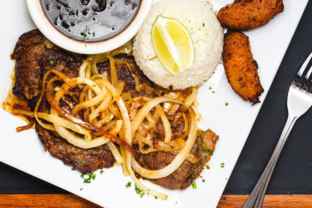 bistec_palomilla_-_mojo_marinated_pan_seared_NY_strip_steak_with_caramelized_onion_and_citrus_1_1024x1024 /upload/thumbnail1/2025/2/24/216773/thumb2